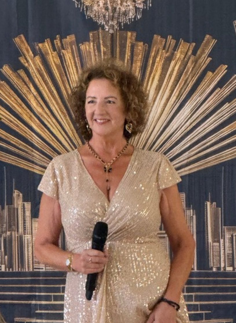 Teresa Wagstaff singing in a gold sequinned dress